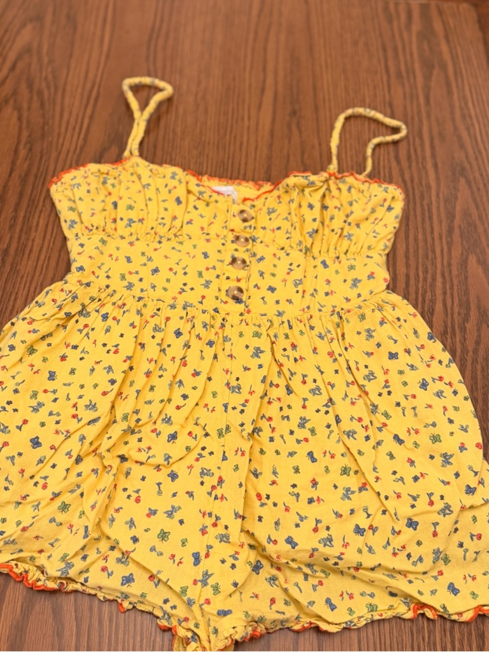 Urban Outfitters yellow romper with butterfly print and button-up front